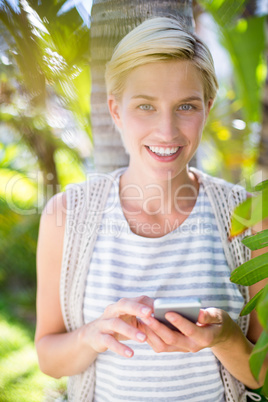 Pretty blonde woman texting with her mobile phone