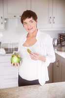 Pregnant woman eating jar of pickles