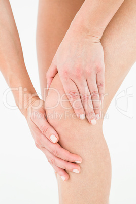 Natural woman touching her painful knee