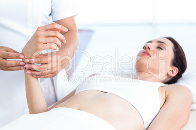 Physiotherapist examining her patients wrist