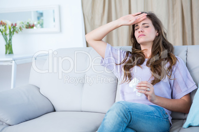 Sick woman touching her forehead
