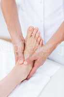 Physiotherapist doing foot massage