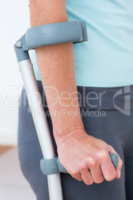 Woman standing with crutch