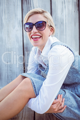 Pretty blonde woman wearing sun glasses