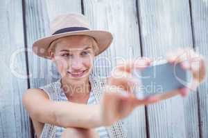 Pretty blonde woman taking selfie