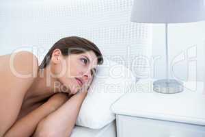 Natural woman lying in her bed