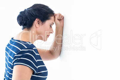 Sad woman leaning against the wall