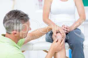 Doctor examining his patients knee