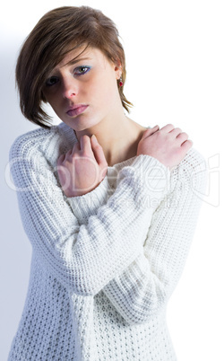 Sad pretty brunette looking at camera with arms crossed