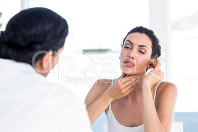 Woman showing her throat to her doctor