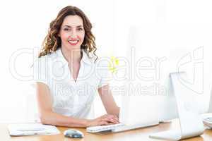 Smiling businesswoman working with computer
