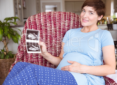 Pregnant woman looking at ultrasound scans