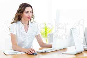 Smiling businesswoman working with computer