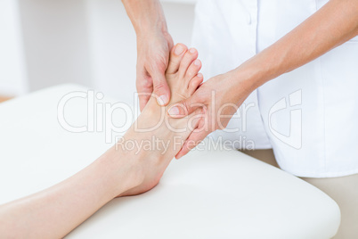 Physiotherapist doing foot massage