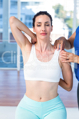 Woman stretching her arm with her therapist