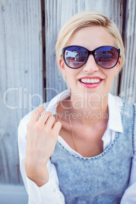 Pretty blonde woman wearing sun glasses