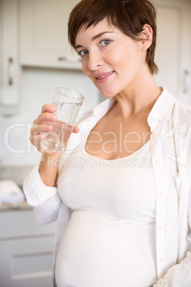 Pregnant woman having a glass of water