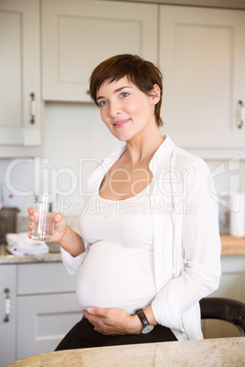 Pregnant woman having a glass of water