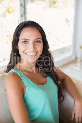 Pretty brunette sitting on the armchair