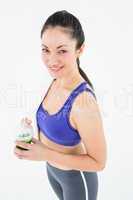 Attractive woman holding green juice