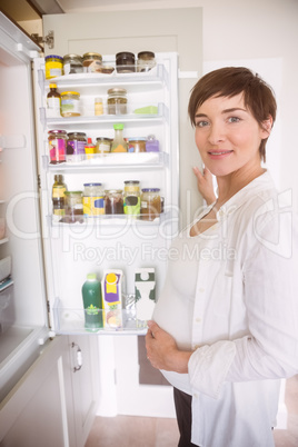 Pregnant woman opening the fridge