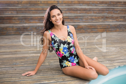 Pretty brunette sitting in swimwear