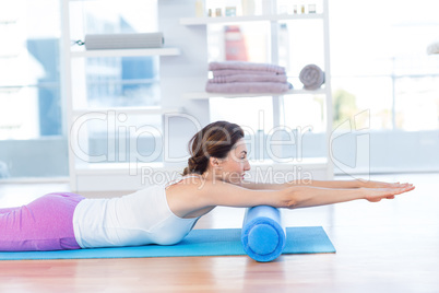 Smiling woman lying on exercise mat