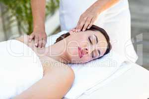 Brunette receiving neck massage