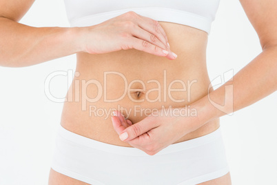 Fit woman with hands on her stomach
