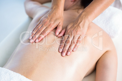 Smiling brunette getting back massage