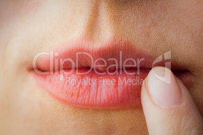 Woman pointing to her lips