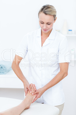 Physiotherapist doing foot massage