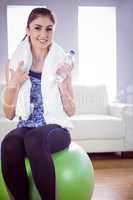 Fit woman with towel and water bottle