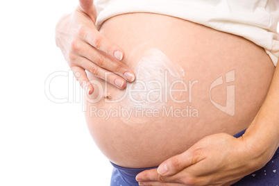 Pregnant woman with cream on bump