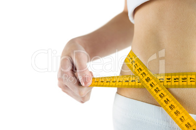 Slim woman measuring her waist