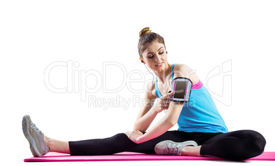 Fit woman stretching on exercise mat