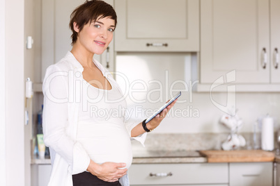 Pregnant woman using tablet pc