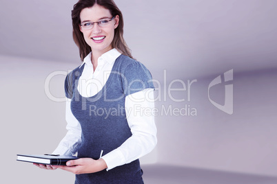 Composite image of happy woman holding diary