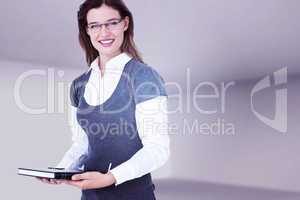 Composite image of happy woman holding diary