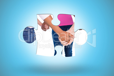 Composite image of women wearing pink for breast cancer holding