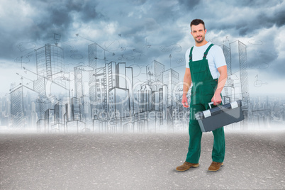 Composite image of repairman holding toolbox