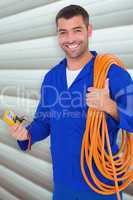 Composite image of smiling electrician with wire roll and multim
