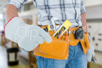 Composite image of technician using adjustable wrench against wh