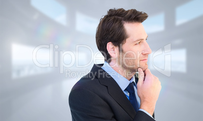 Composite image of thinking businessman touching his chin