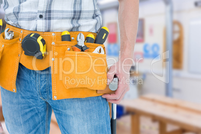 Composite image of technician with tool belt around waist