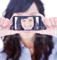 Composite image of hands holding smartphone