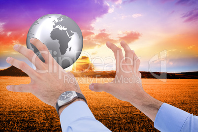 Composite image of businessman holding something with his hands