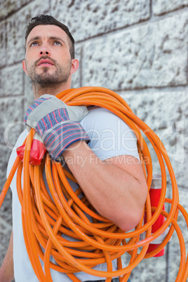 Composite image of repairman holding wire roll