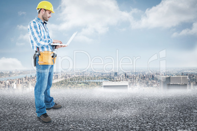 Composite image of full length of repairman using laptop