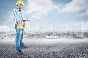 Composite image of full length of repairman using laptop